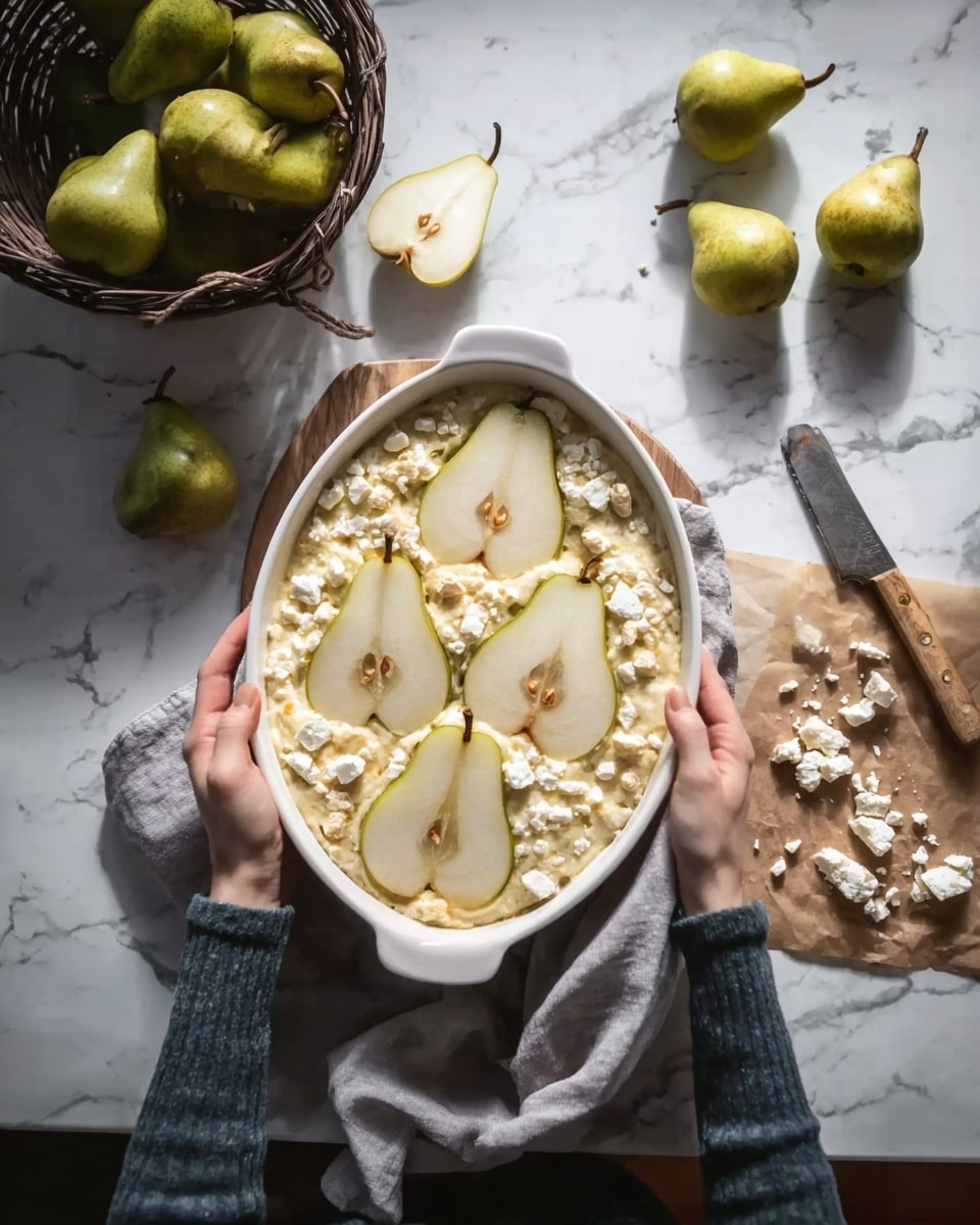 An oval white dish is held by a woman's hands above a white marbled surface with soft natural light. Inside the dish is a mixture topped with six pear slices arranged in two rows of three, each pear slice light yellow with dark seeds visible at the center. The dish looks like it has a creamy, slightly textured base, and there are small chunks of a crumbly white cheese scattered on top, especially around the pear slices. A gray cloth napkin is partly under the dish, and to the right, there is some crumbled cheese on brown parchment paper with a small wooden knife resting on it. Nearby, a dark wicker basket holds multiple green pears, with a few pears outside the basket on the white marbled surface. Photo taken with an iphone --ar 4:5 --v 7