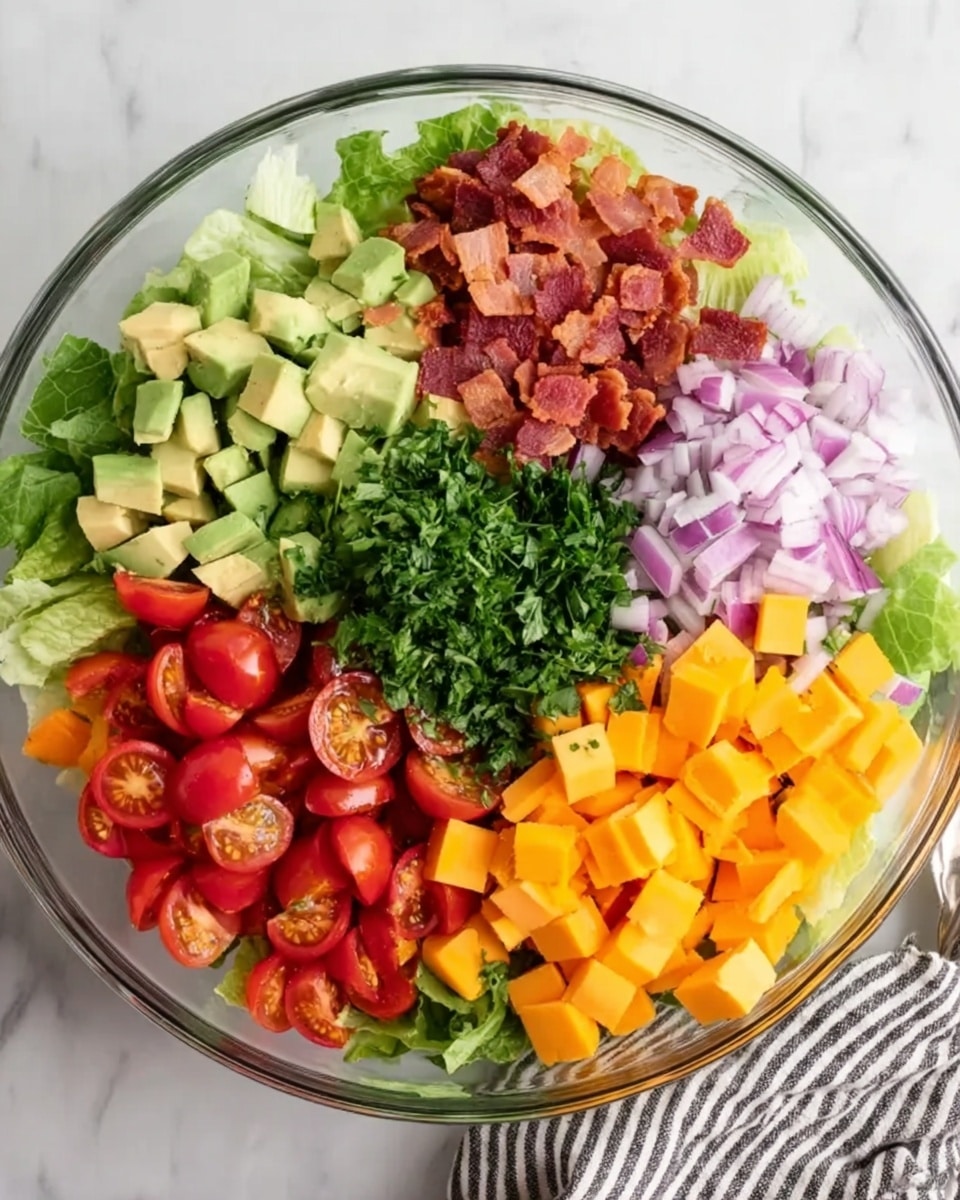 A clear glass bowl filled with seven separate layers of fresh ingredients arranged side by side. Starting from the top left, there are crisp green romaine lettuce leaves, next to finely chopped red bacon pieces with a rough texture, followed by small cubed light green avocado pieces. Moving down, there are finely chopped red onion pieces with a shiny texture, bright orange cubes of cheddar cheese, halved red cherry tomatoes with juicy insides on the bottom left, and in the center, a layer of chopped fresh green parsley. The bowl sits on a white marbled surface with part of a striped cloth visible at the bottom right. Photo taken with an iphone --ar 4:5 --v 7